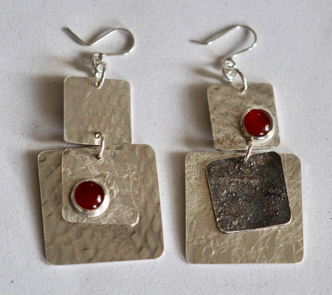Carnelian, the stone of the brave. It generates self empowerment, creativity, and draws on ones sexual energies. I like to say it has (therefore gives) attitude in the nicest possible way.